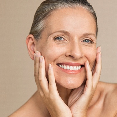 Smiling senior woman, enjoying benefits of All-on-4 dental implants