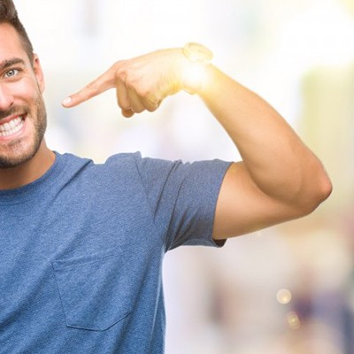 man pointing to his straight white smile 