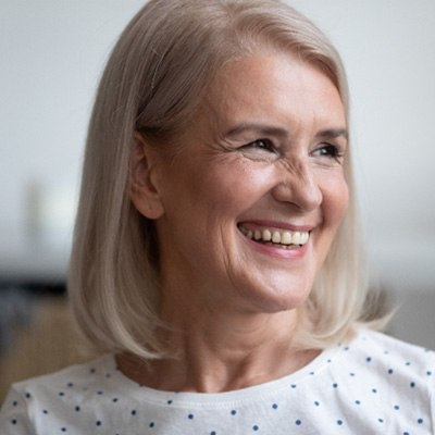 woman smiling after getting dental implants