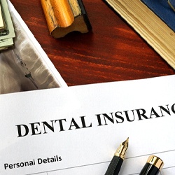 Dental insurance paperwork on wooden desk