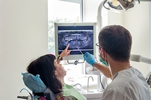 dentist showing a patient their dental X-rays 