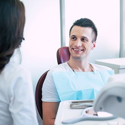 Patient conversing with dental team member