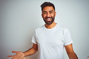 a man smiling with hybrid dentures