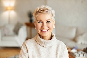 a woman smiling with hybrid dentures