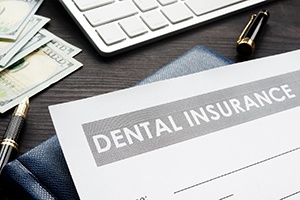 Dental insurance form resting on a crowded desk