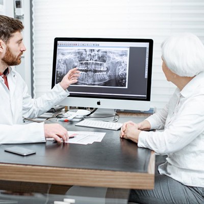 dentist showing a patient their X-rays