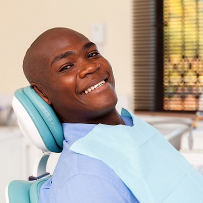 Man smiling after dental implant tooth replacment