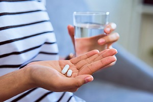 Closeup of patient taking pain medication