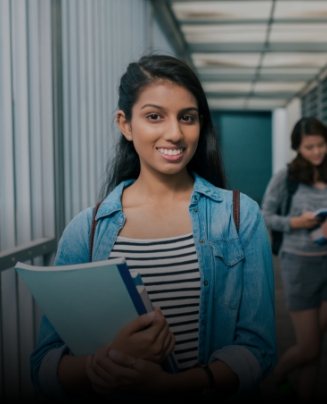 Teenage girl smiling in high school hallway