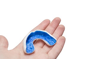 person holding mouthguard