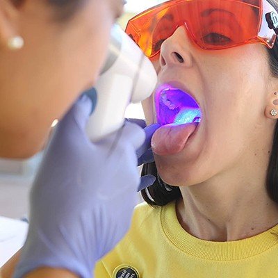 Woman receiving oral cancer screening