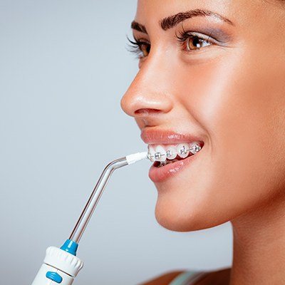 Woman using water flosser