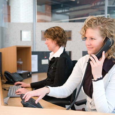 woman answering phone at front desk