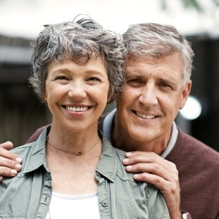 Smiling older man and woman outdoors