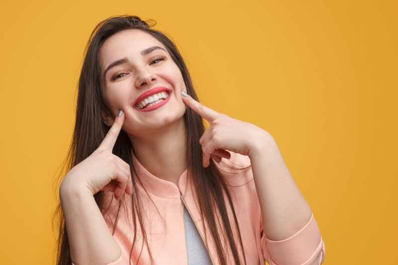 woman smiling after visiting cosmetic dentist in Springfield