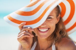 a woman with a beautiful smile during summer from cosmetic dental treatments